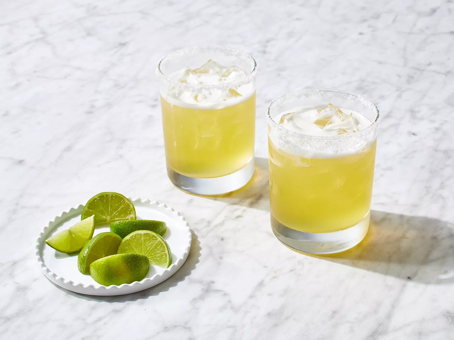 mixture poured into glasses with limes on the side