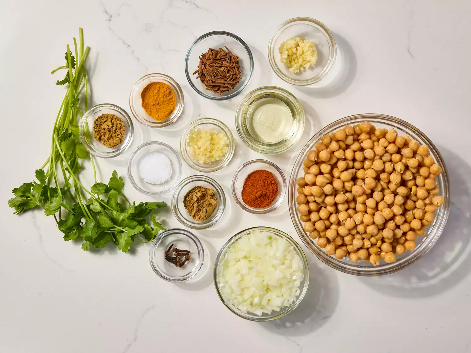 Assorted ingredients for chickpea curry arranged on a countertop.