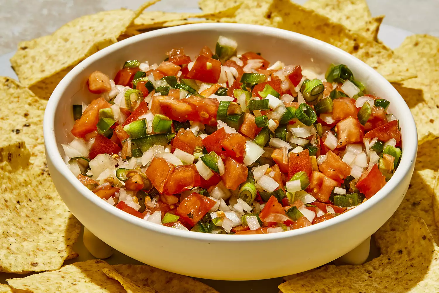 a super close up view of a bowl of fresh pico de gallo