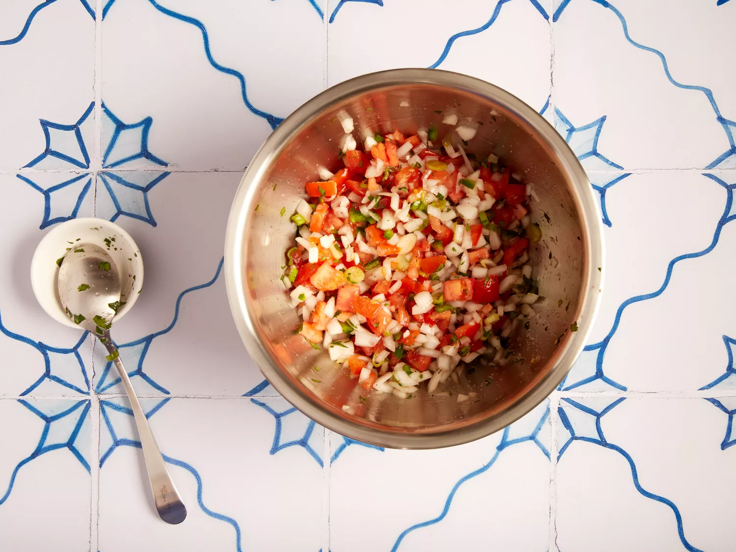 Seasoned Pico de Gallo in a metal bowl. 