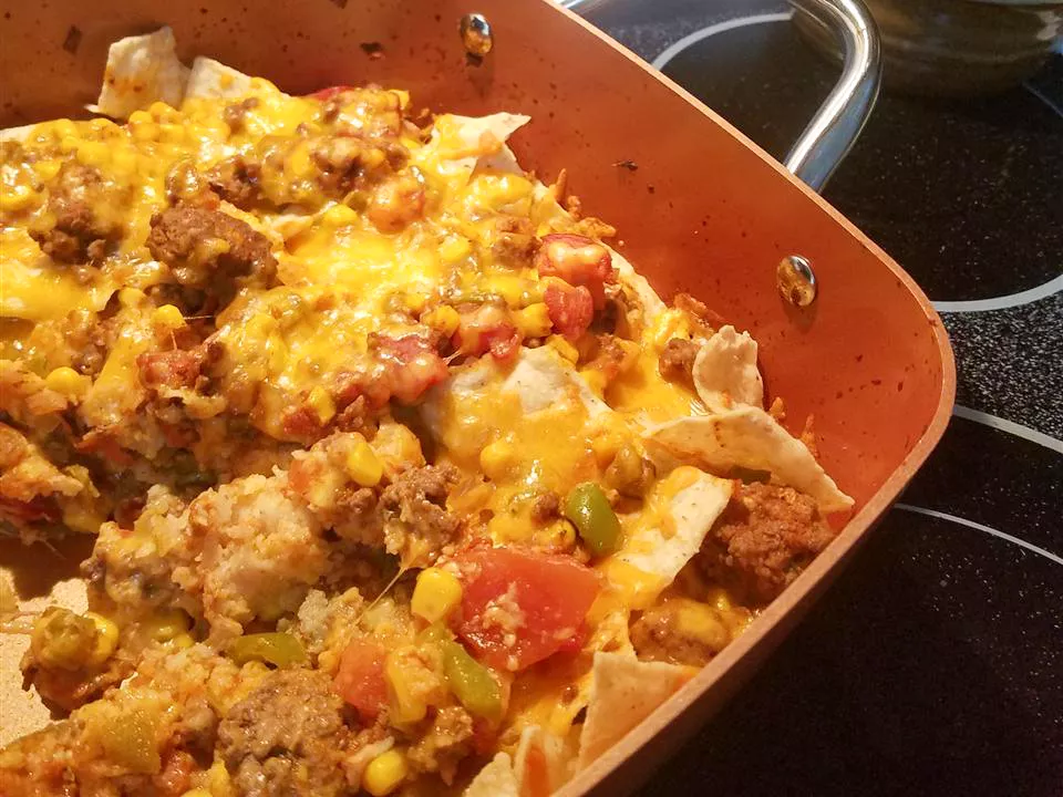 Close up view of a taco bake in a baking dish on a stove top