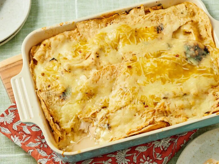 Green chile chicken enchilada casserole in a baking dish