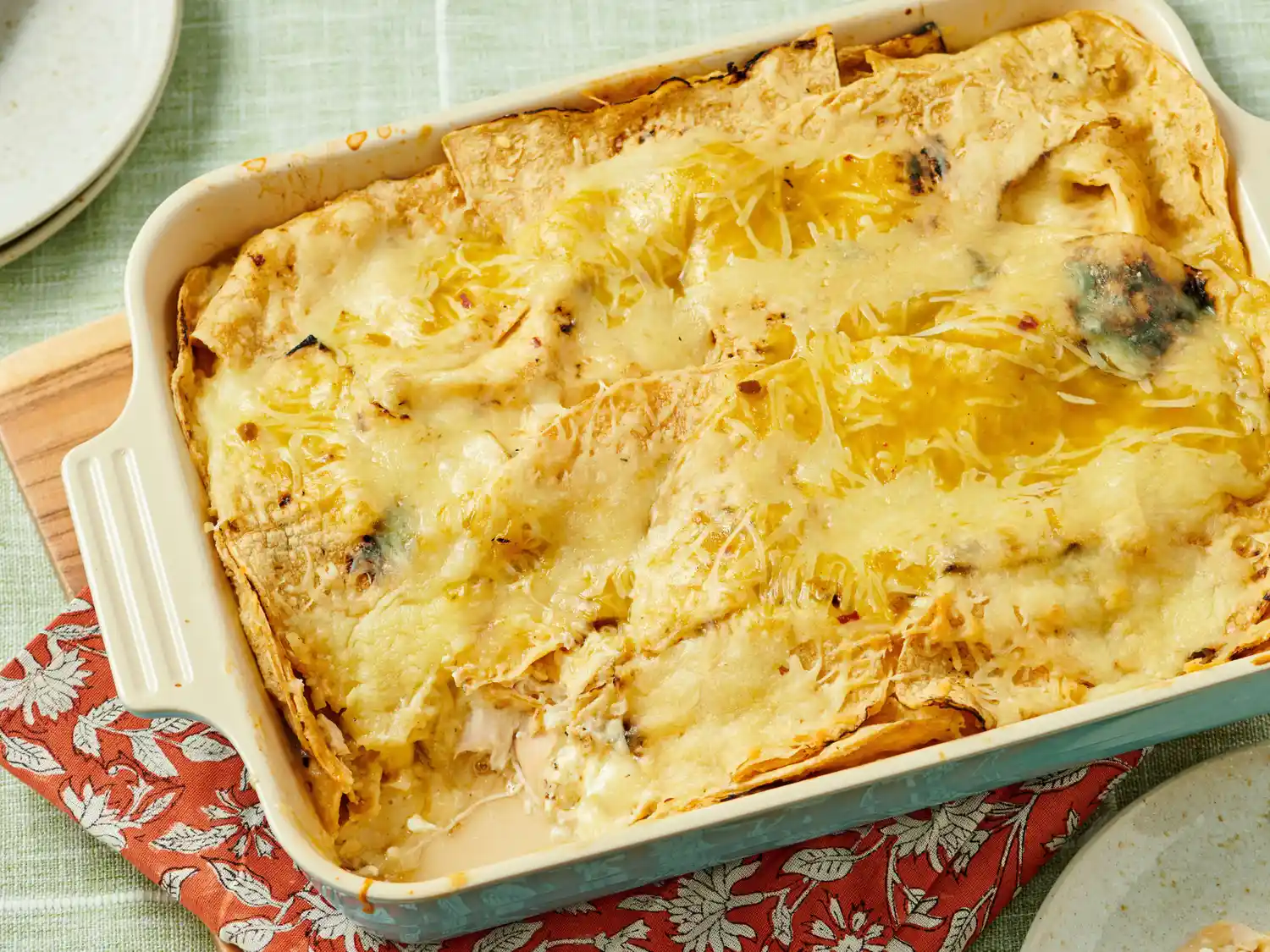 Green chile chicken enchilada casserole in a baking dish