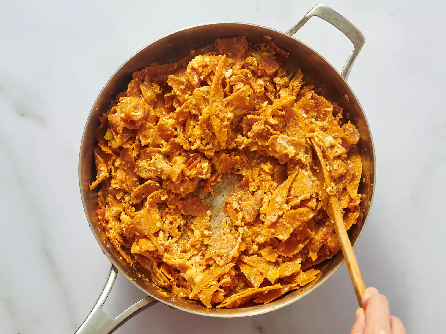A pan of chilaquiles being stirred