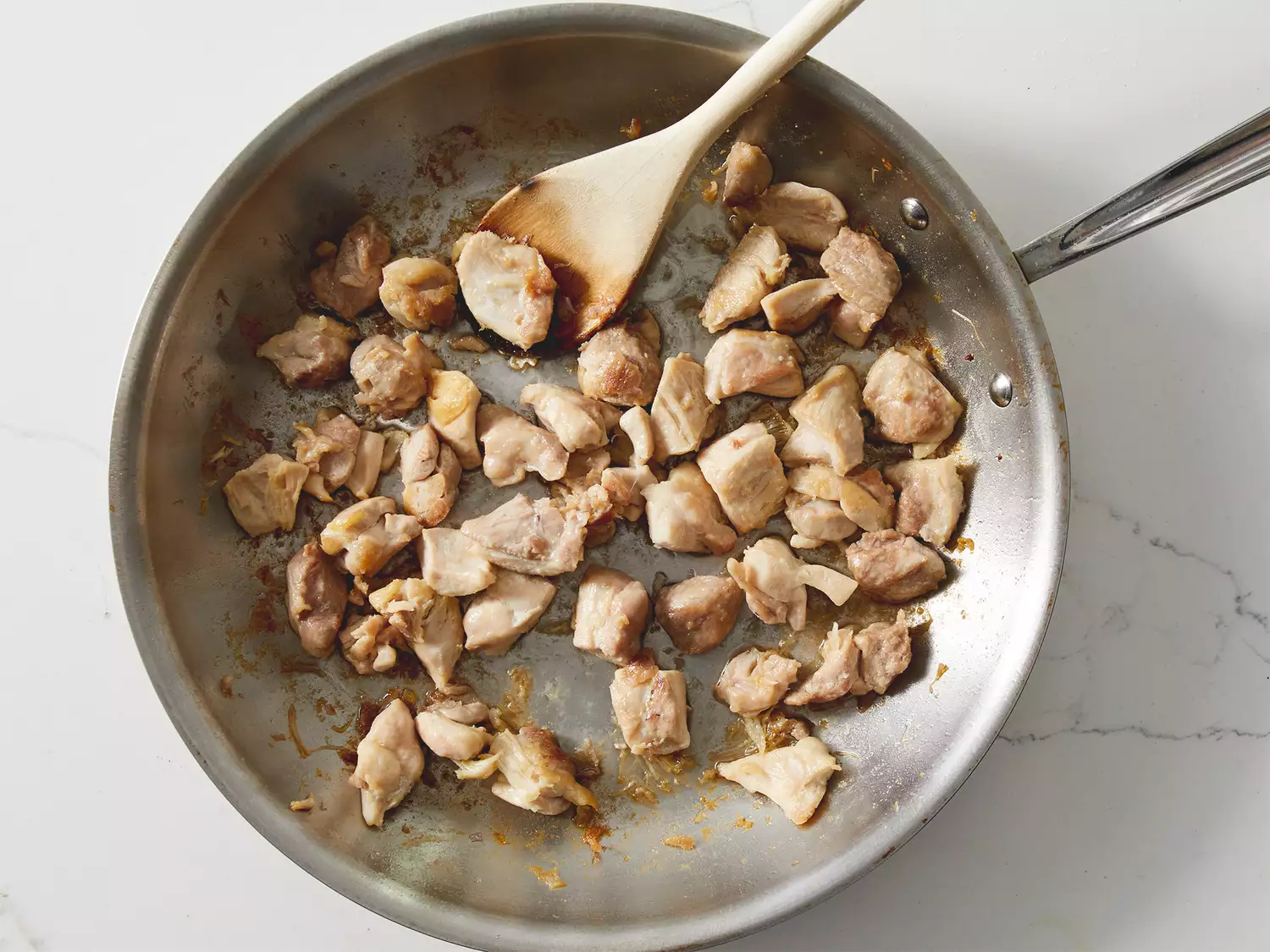 Cooked chicken in skillet.