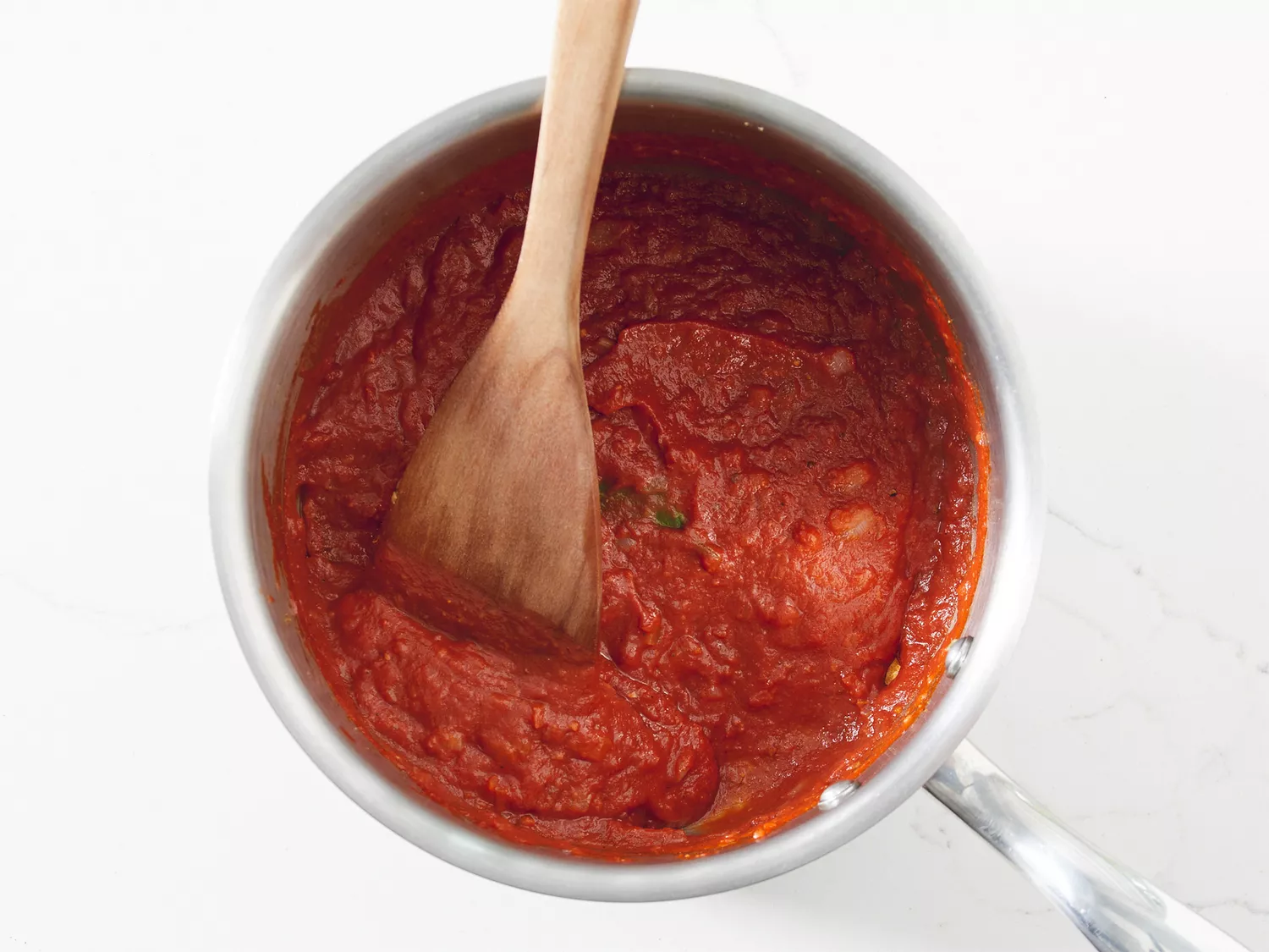 Mixture with tomato paste, butter, ginger-garlic paste, lemon juice, 1 teaspoon garam masala, chili powder, cumin, and bay leaf.