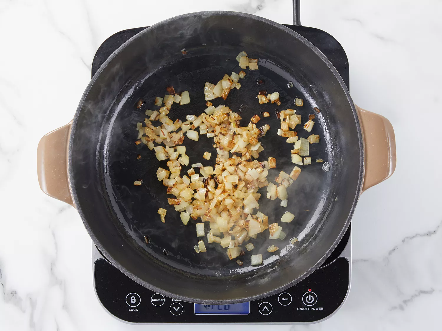 Onions sautéing in a skillet. 