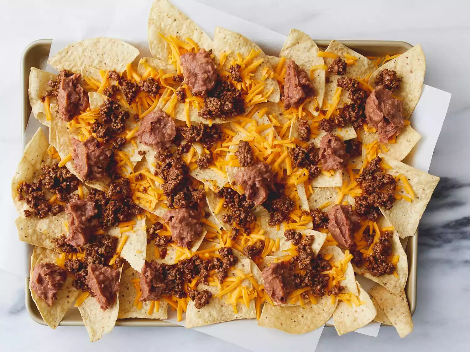 Meat placed on nachos.