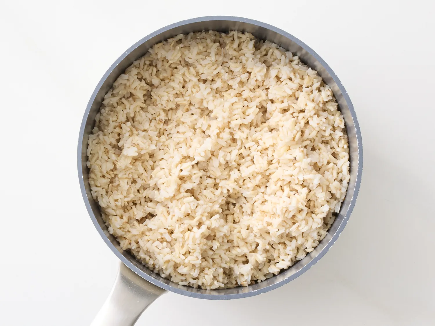 Cooked rice in a saucepan with a handle