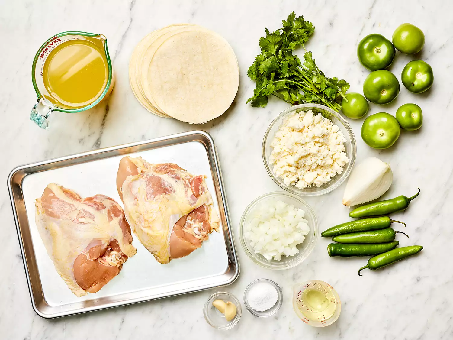 Authentic Enchiladas Verdes ingredients on a marble counter 