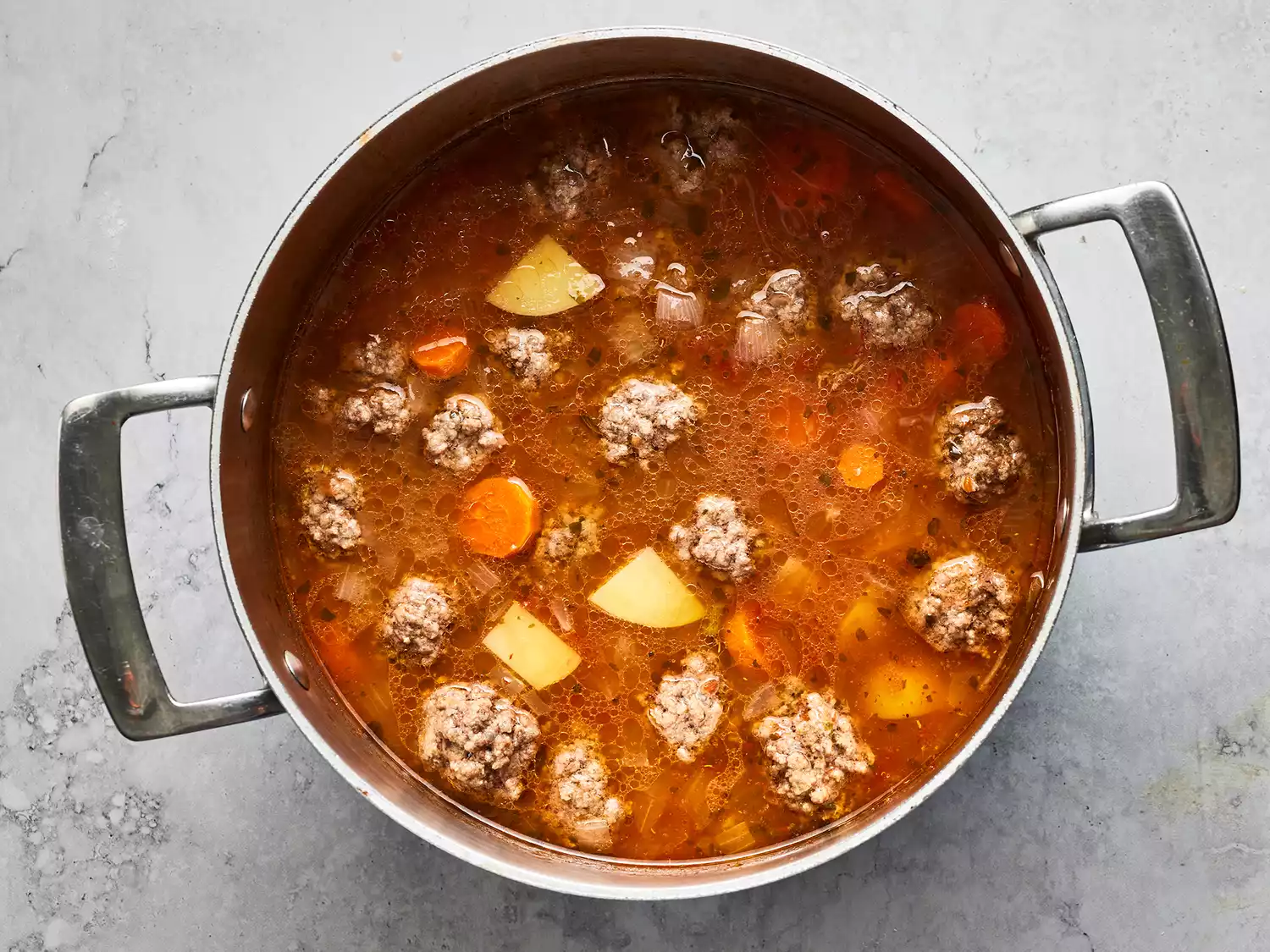 Overhead shot of albondigas soup cooking in a pot
