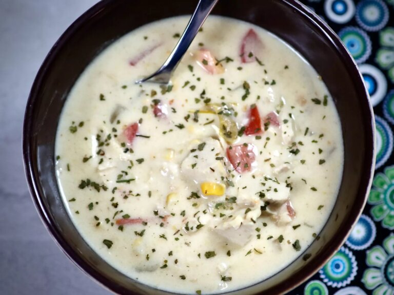 Overhead view of creamy potato corn chowder in black bowl