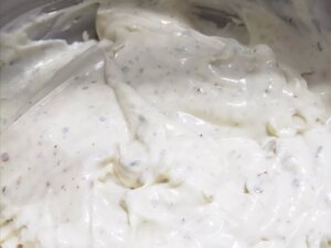 Close up view of mexican white sauce in a metal bowl