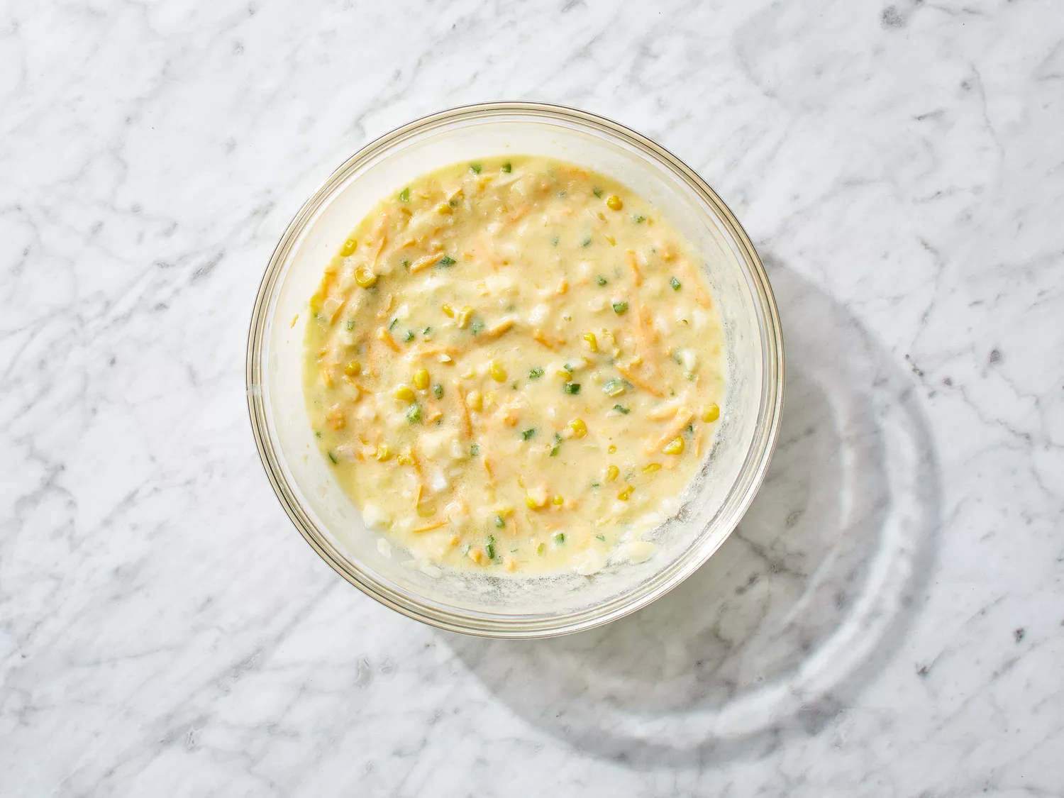 eggs, jalapeño, creamed corn, cheese and onion mixed together in a bowl