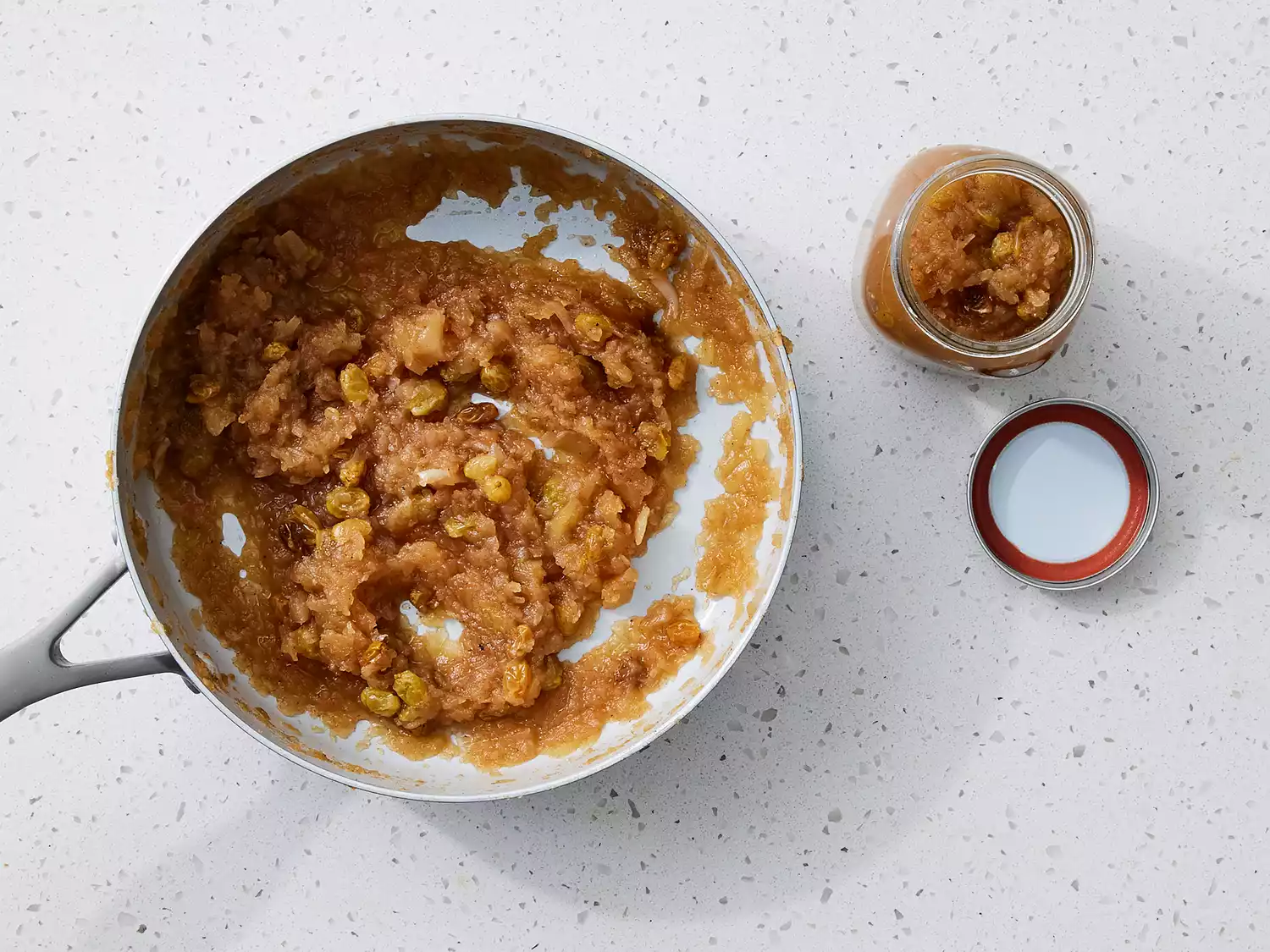 Chutney cooled and being spooned into an airtight jar. 