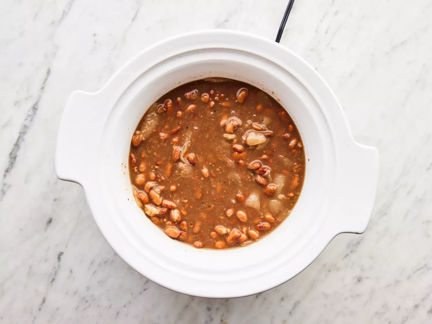 ingredients cooked in slow cooker until beans are very tender.