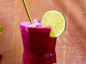 Pink agua de fresca with dragon fruit with straw and lemon wheel