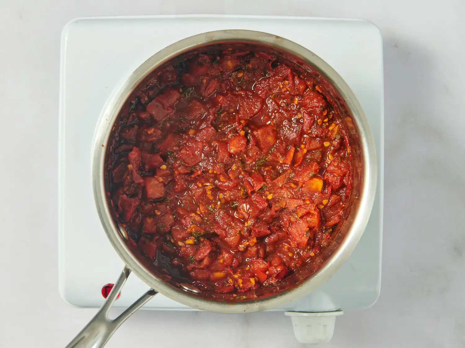 Pot of tomato chutney cooking on a stovetop