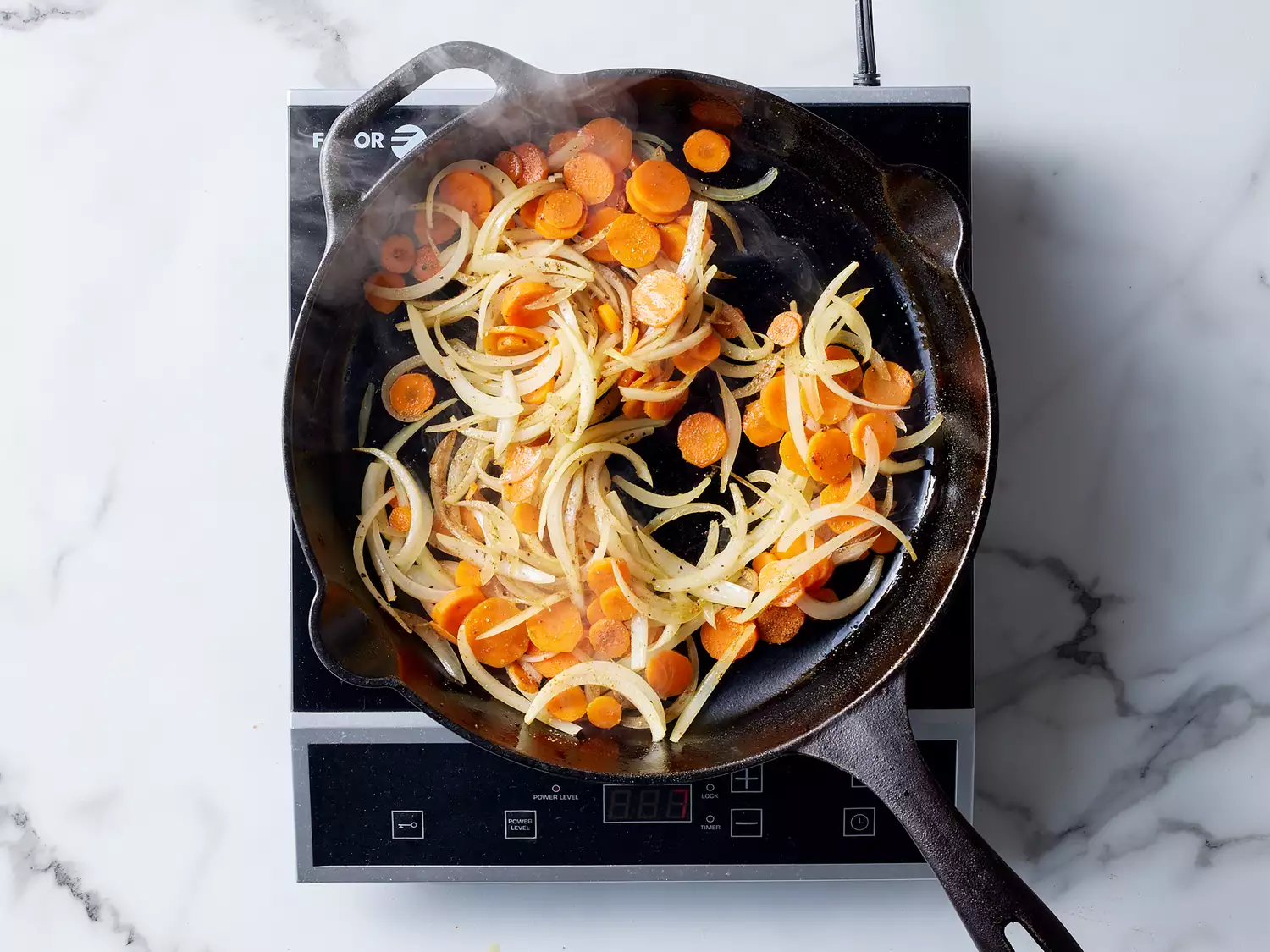 carrots and onions cooked until softened in a cast iron skillet. 