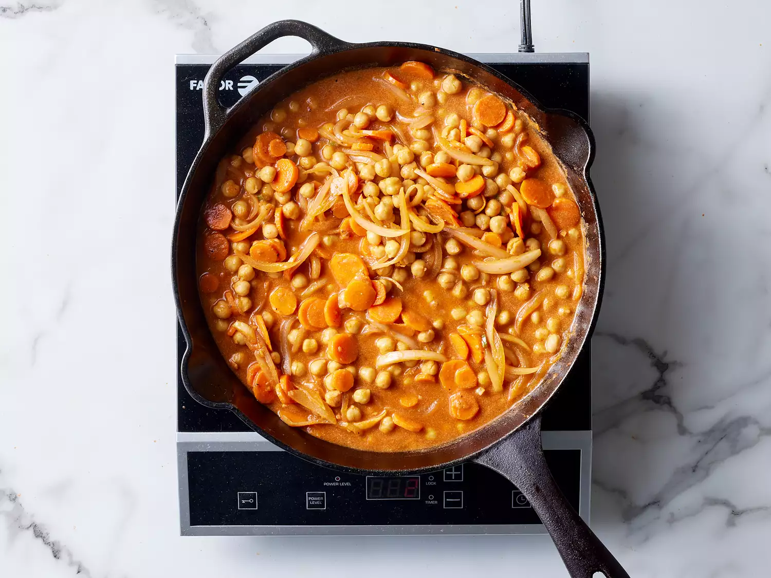 Chickpea Tikka Masala coming together in a cast iron skillet. 