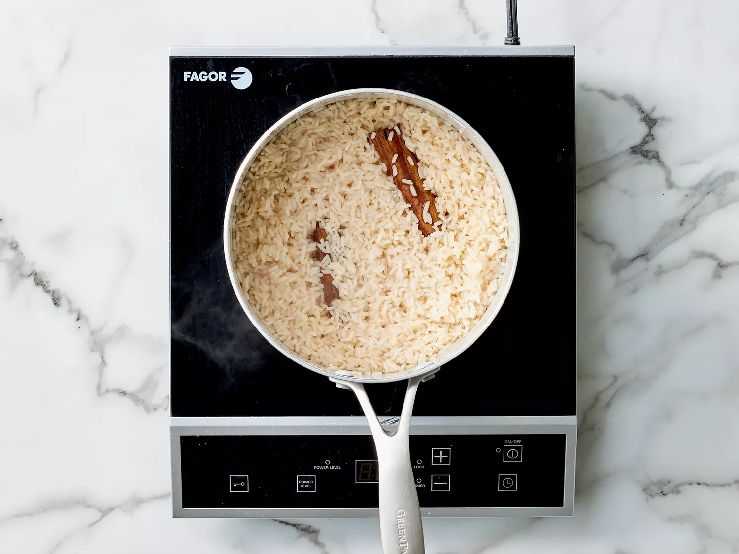 perfectly cooked rice and two cinnamon sticks in a medium sauce pan. 