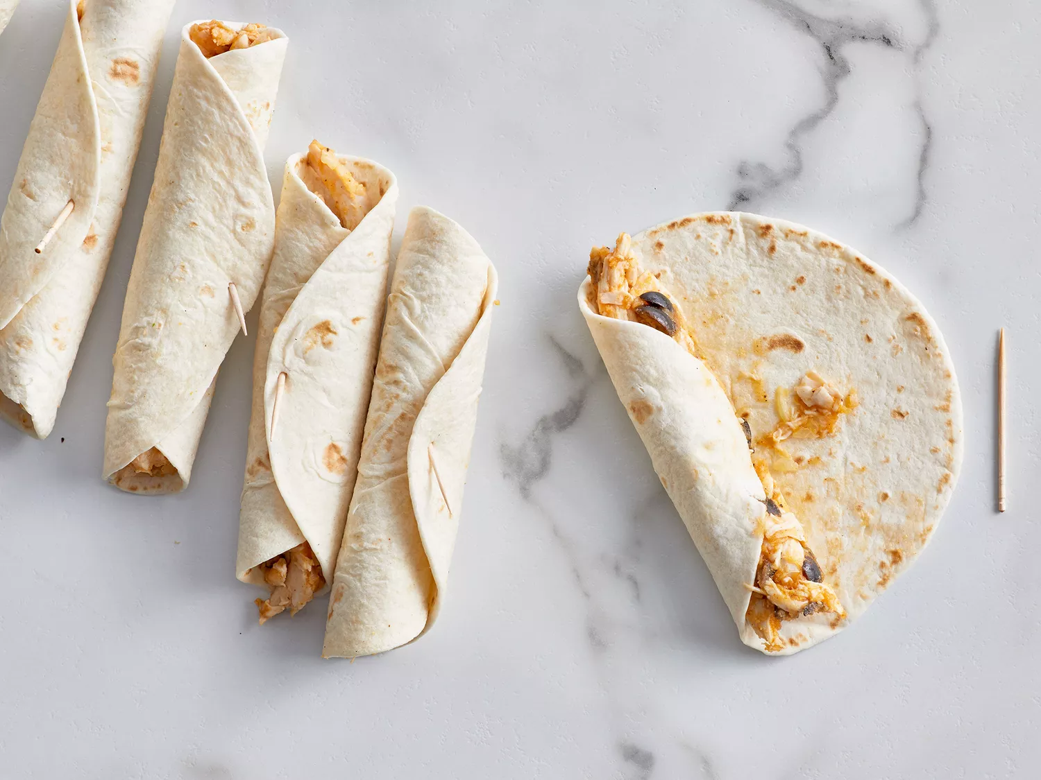 Chicken Flautas - rolling up filling into tortilla
