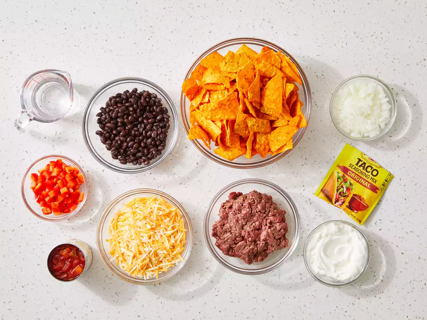 all ingredients to make Dorito casserole gathered on a kitchen counter.