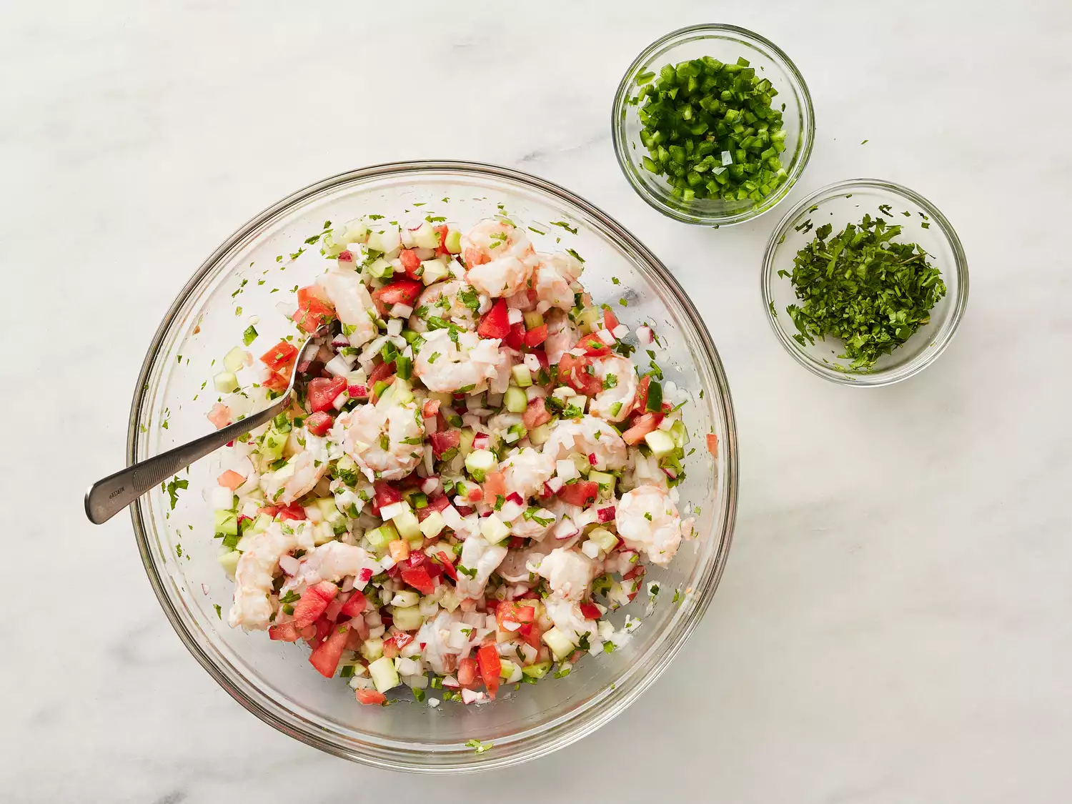 Onions, tomatoes, cucumber, radishes, garlic, cilantro and jalapeño added to bowl.