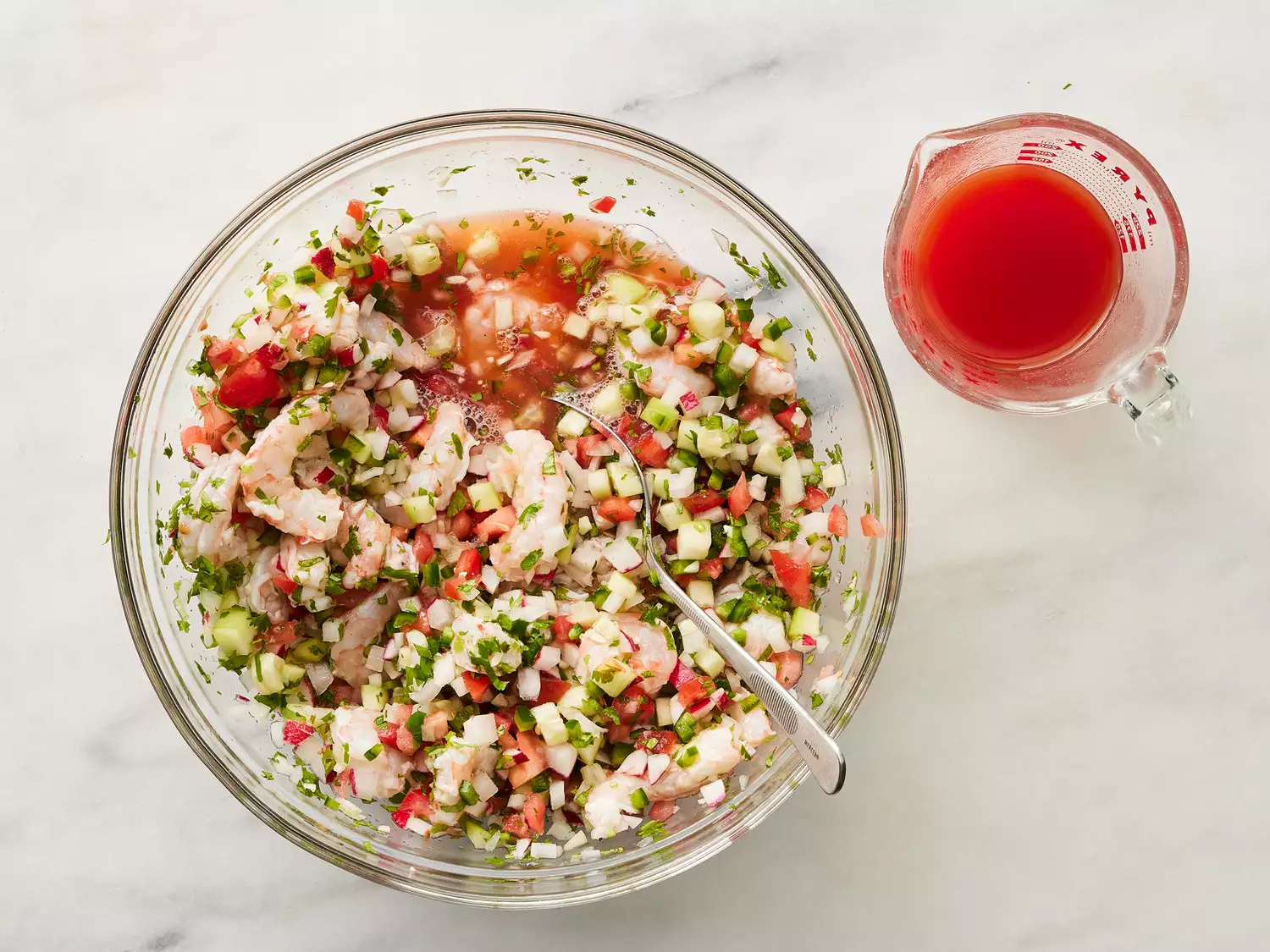 Tomato and clam juice added to bowl.