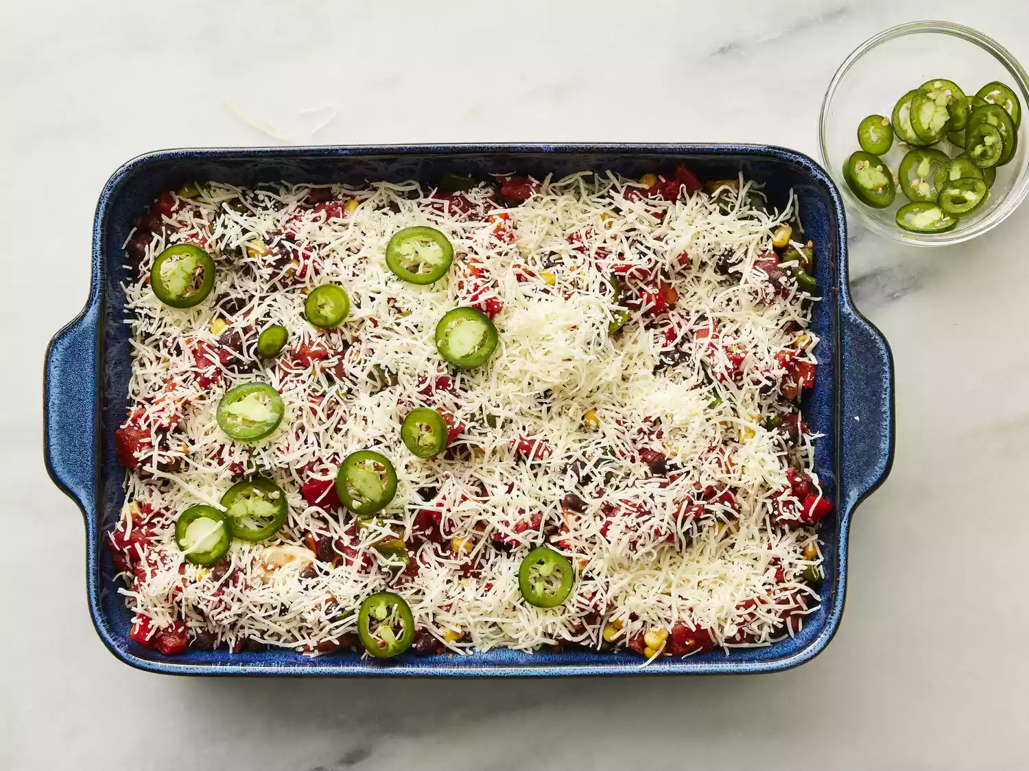 Casserole topped with cheese and jalapeño slices. 