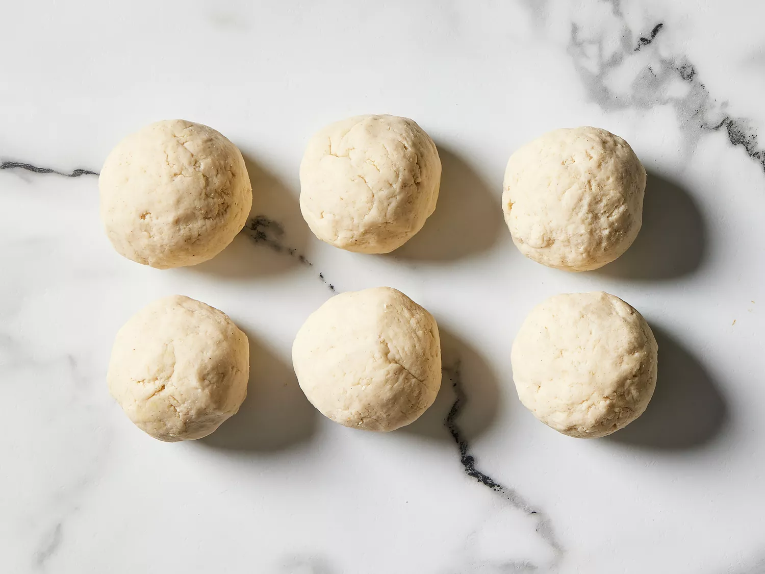dough divided and rolled into six balls