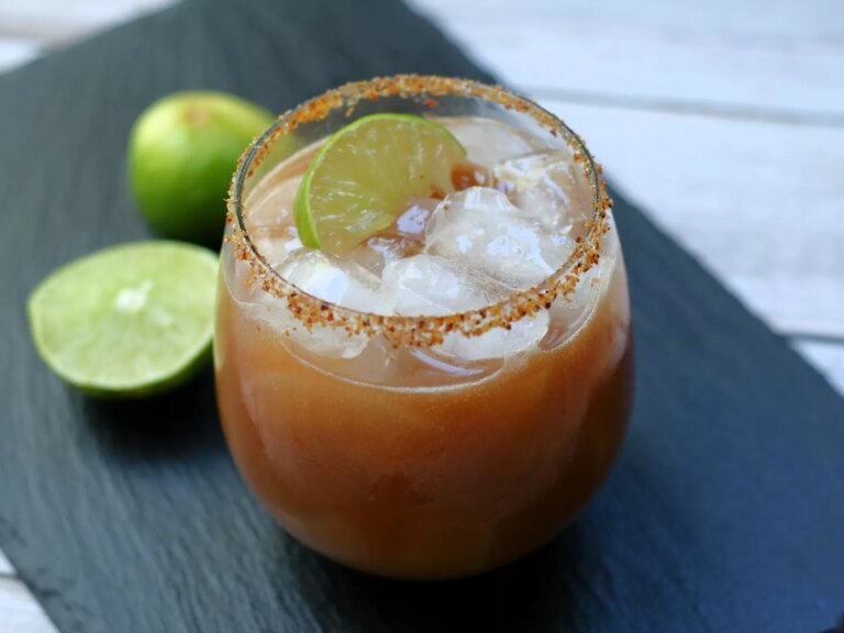 Tamarind margarita with limes and tajin rimmed glass