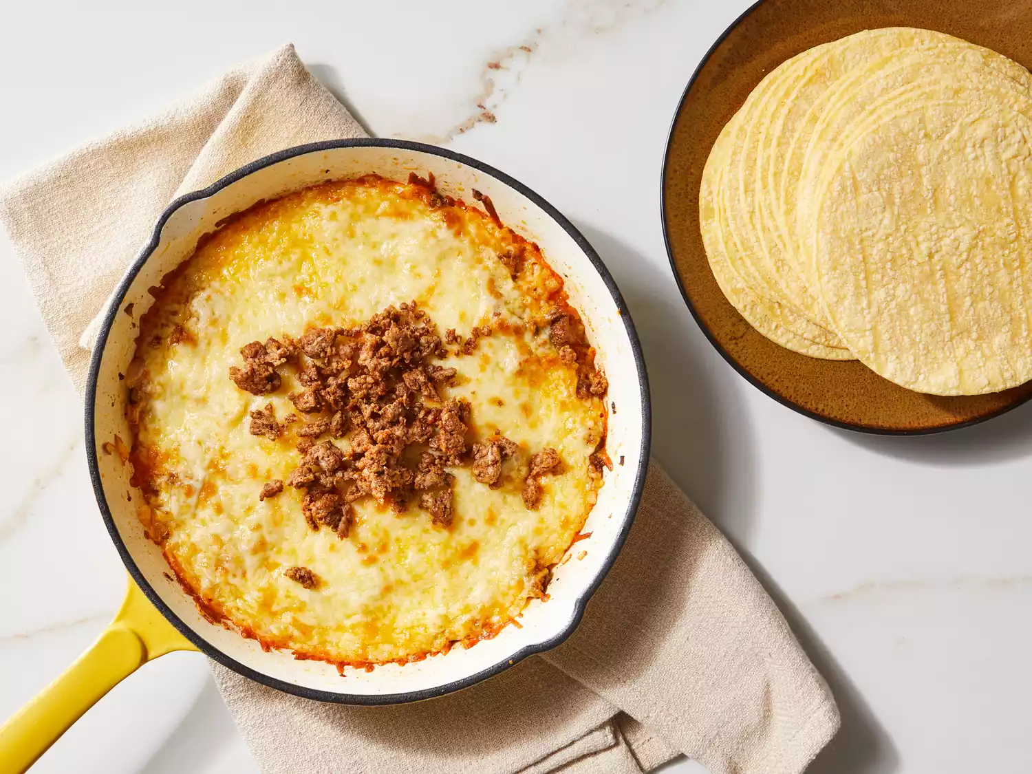 Queso fundido topped with remaining chorizo and served with warm tortillas.
