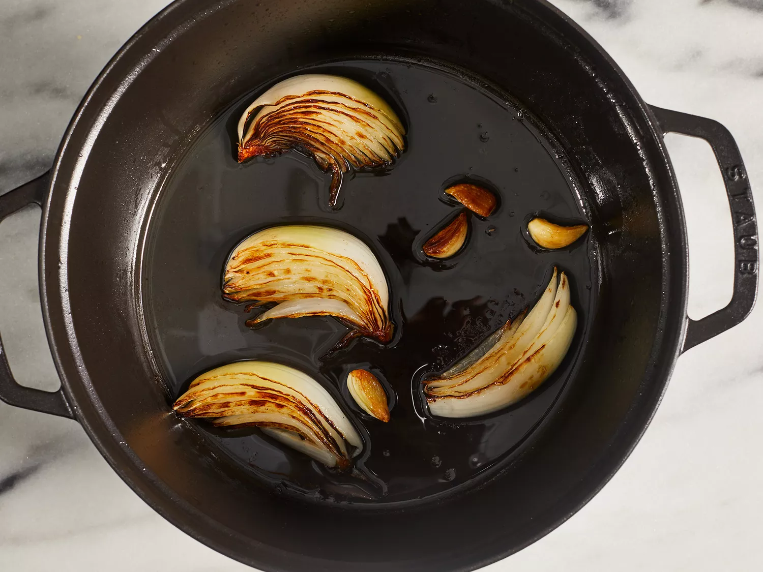 Onions browning in a dutch oven.