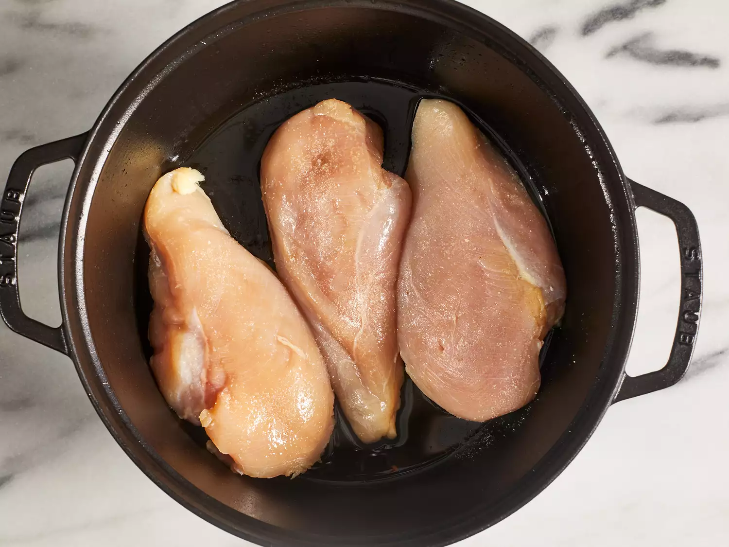 Cook chicken in a pot until golden brown.