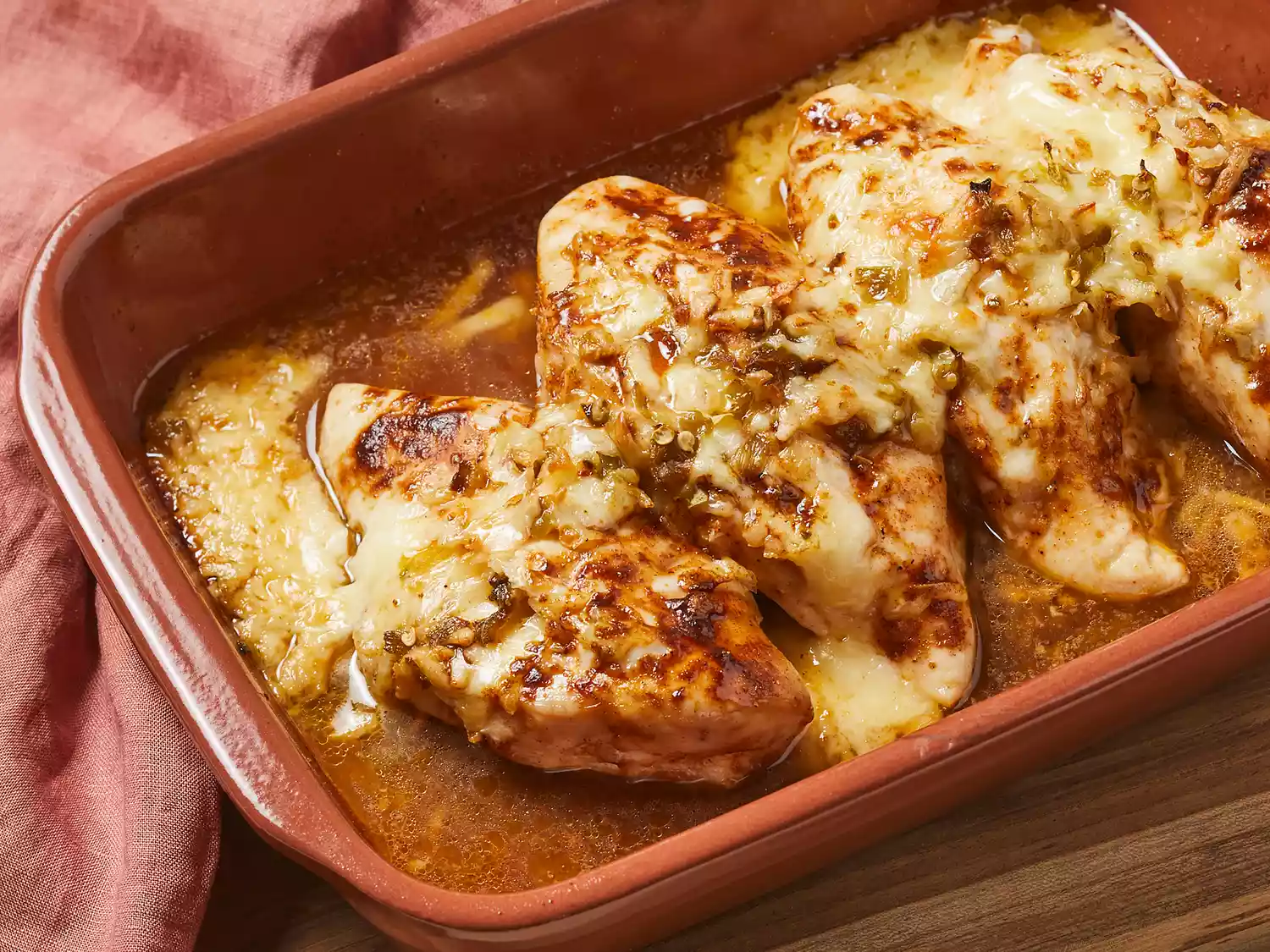 High angle, looking at a baking dish of green chili and cheese chicken