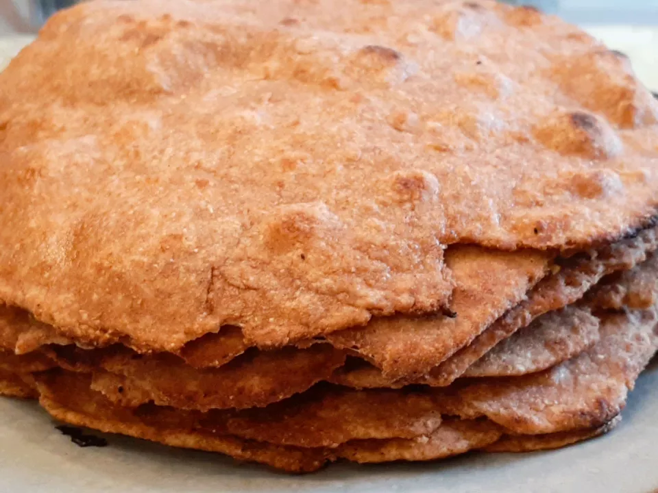 Close up view of a pile of whole wheat chapati on a plate