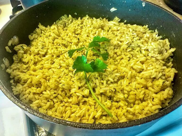 Skillet of bright yellow arroz verde