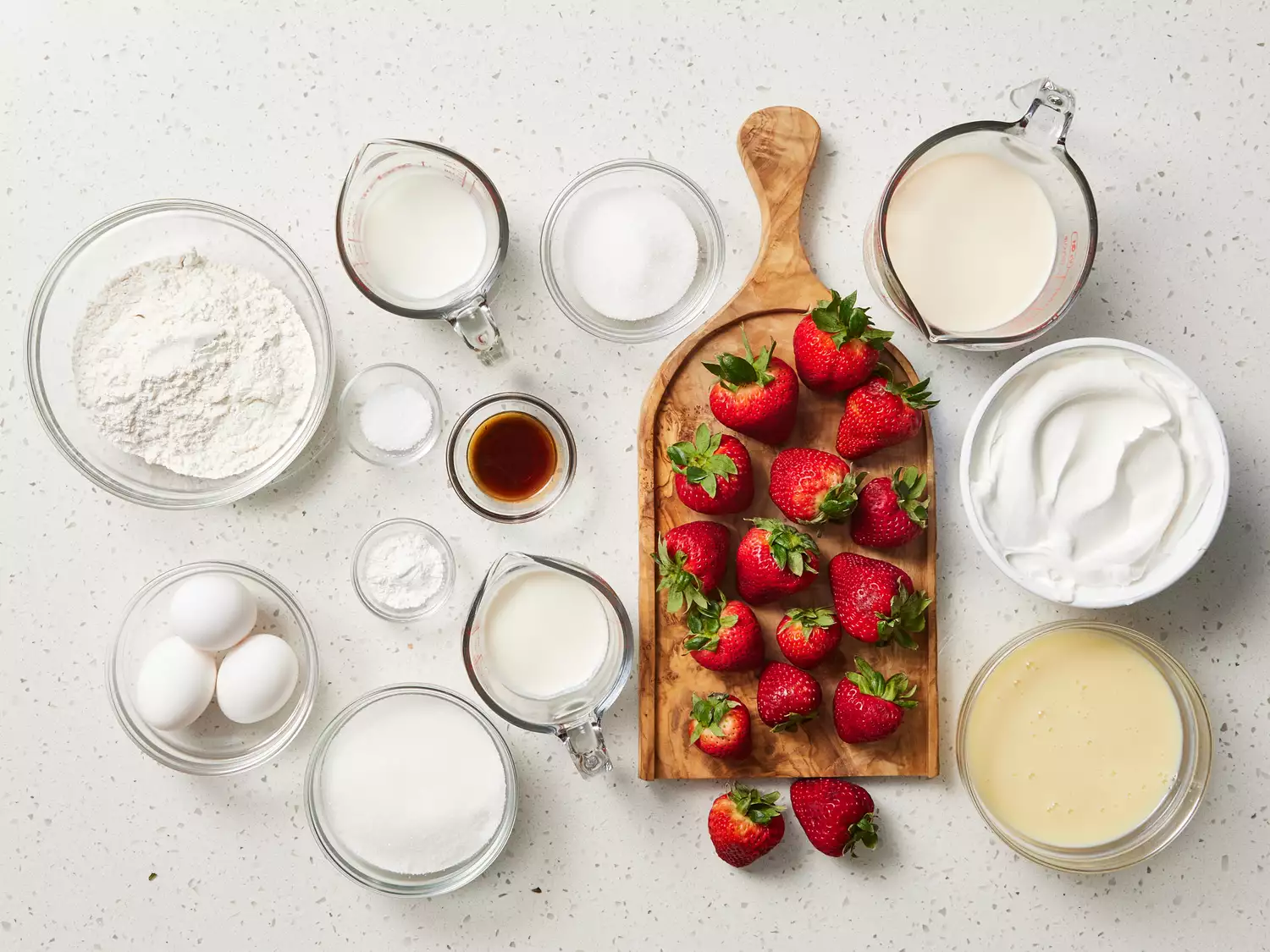 Strawberry Tres Leches Cake ingredients on a white counter 