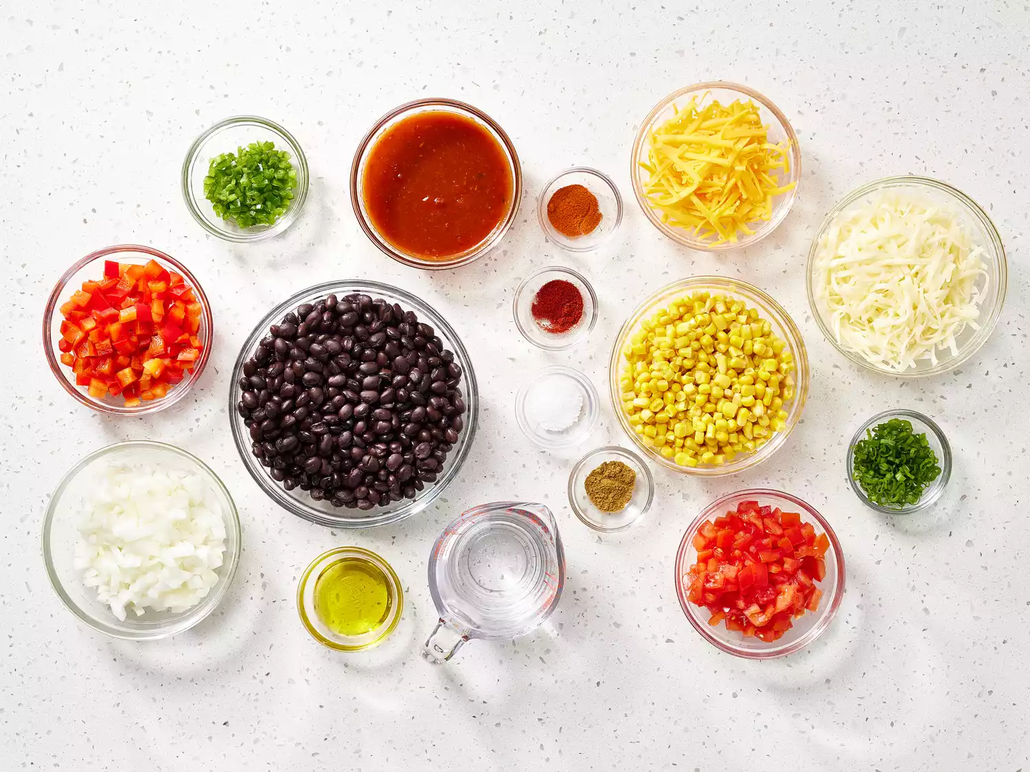 Black Bean Casserole ingredients in glass bowls on a counter 