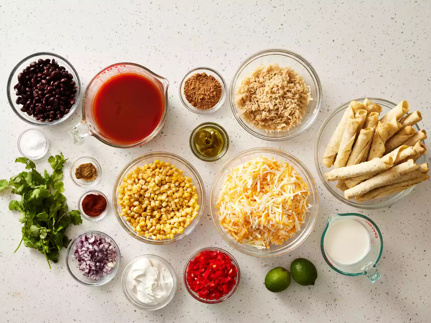 Taquito Casserole ingredients in glass bowls 