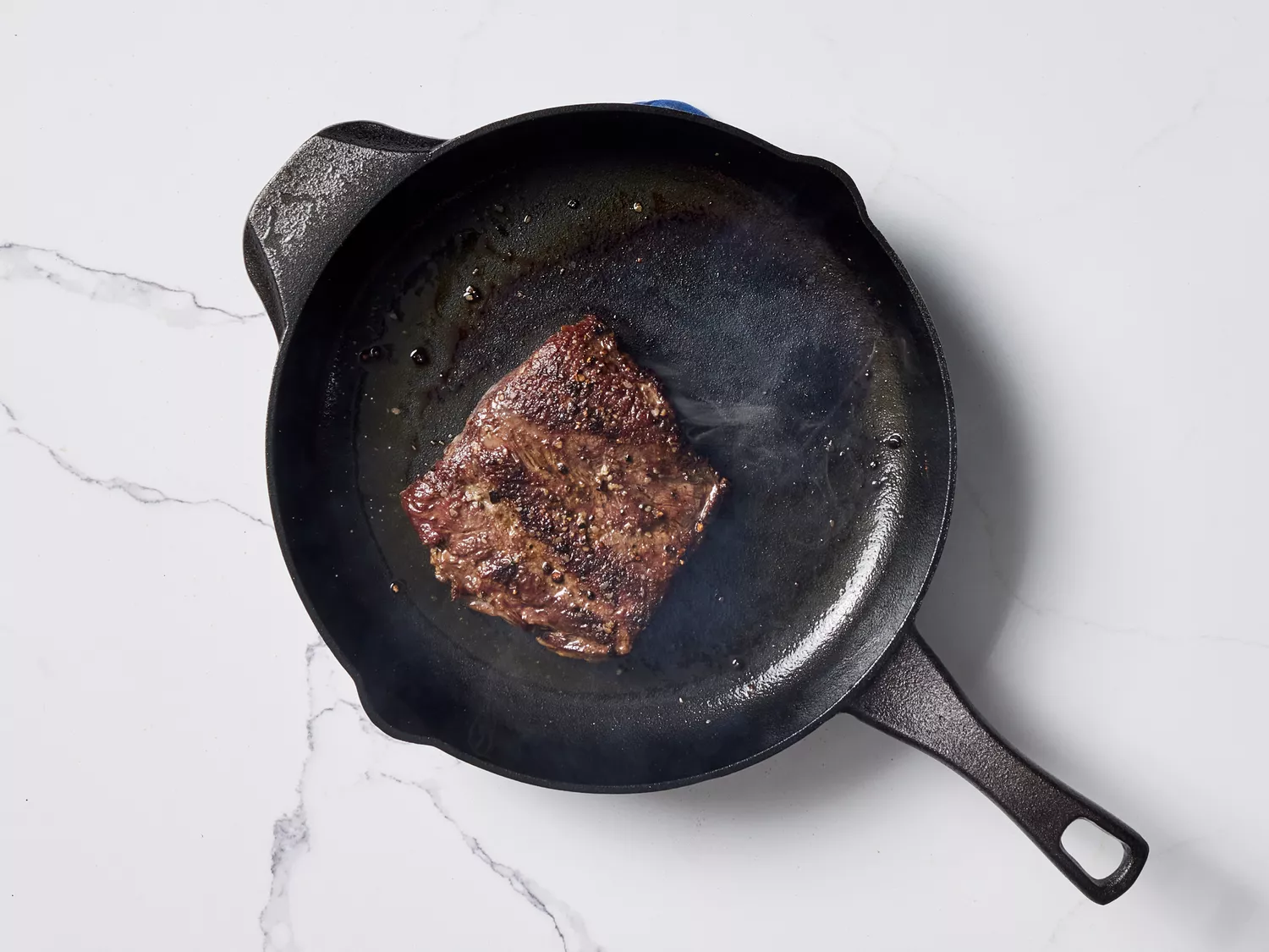 Cooked steak in a cast iron skillet 