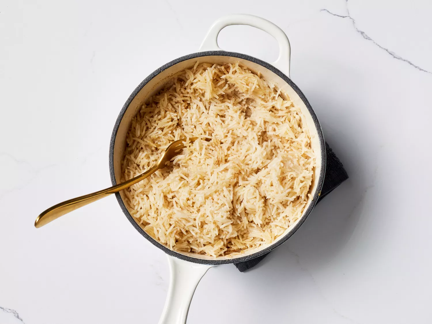 Cooked rice in a pot with a spoon