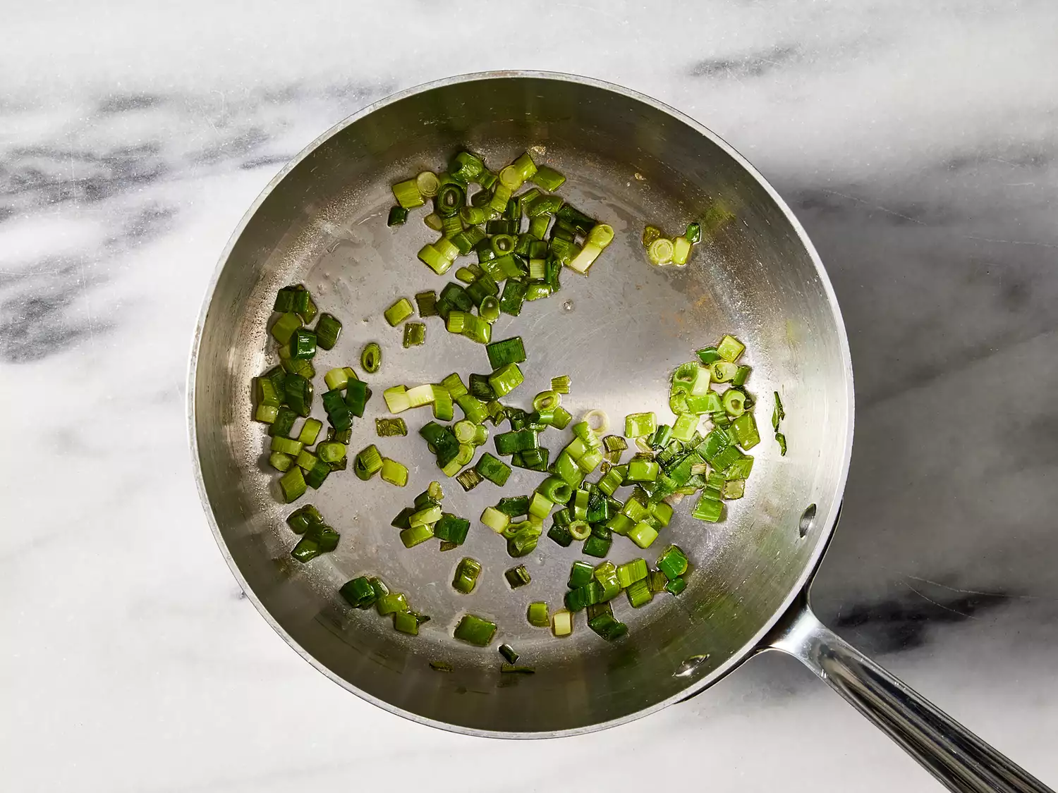 Green onions sautéing in hot butter.