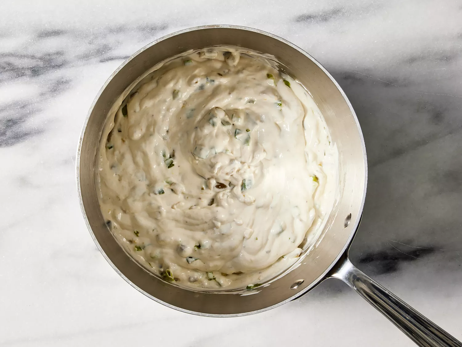 Sour cream, condensed soup, green chiles and garlic powder added to green onions.