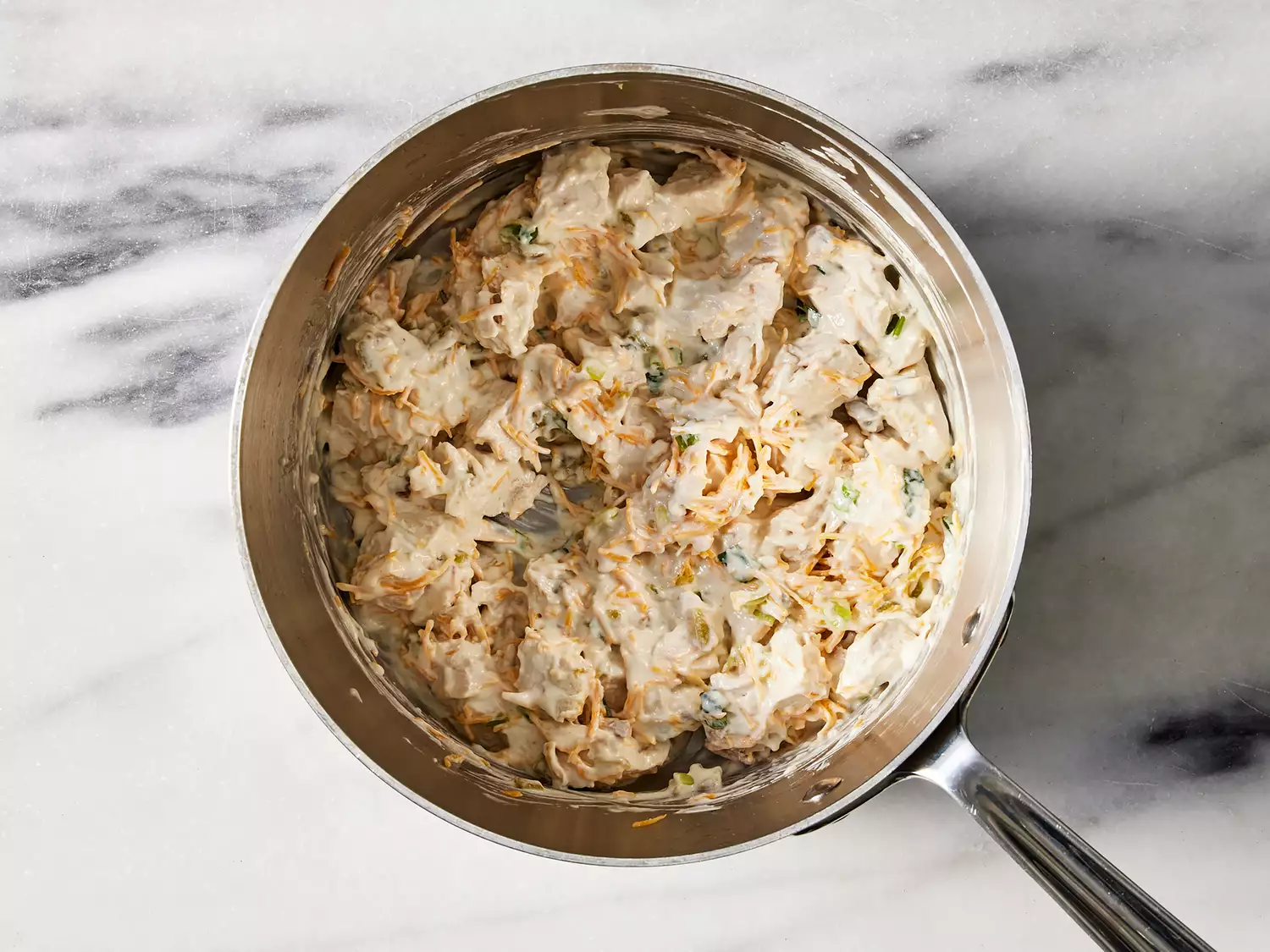 Chicken and cheese added to sauce pan.