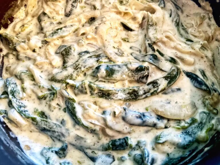 Closeup overhead view of rajas con crema, creamy poblano pepper strips