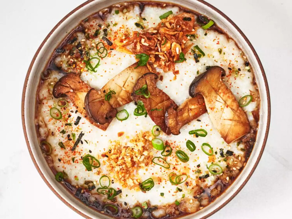 Overhead view of congee rice with many garnishes