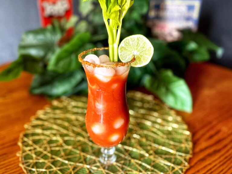 Tall stemmed glass with bloody maria tequila and tomato juice cocktail