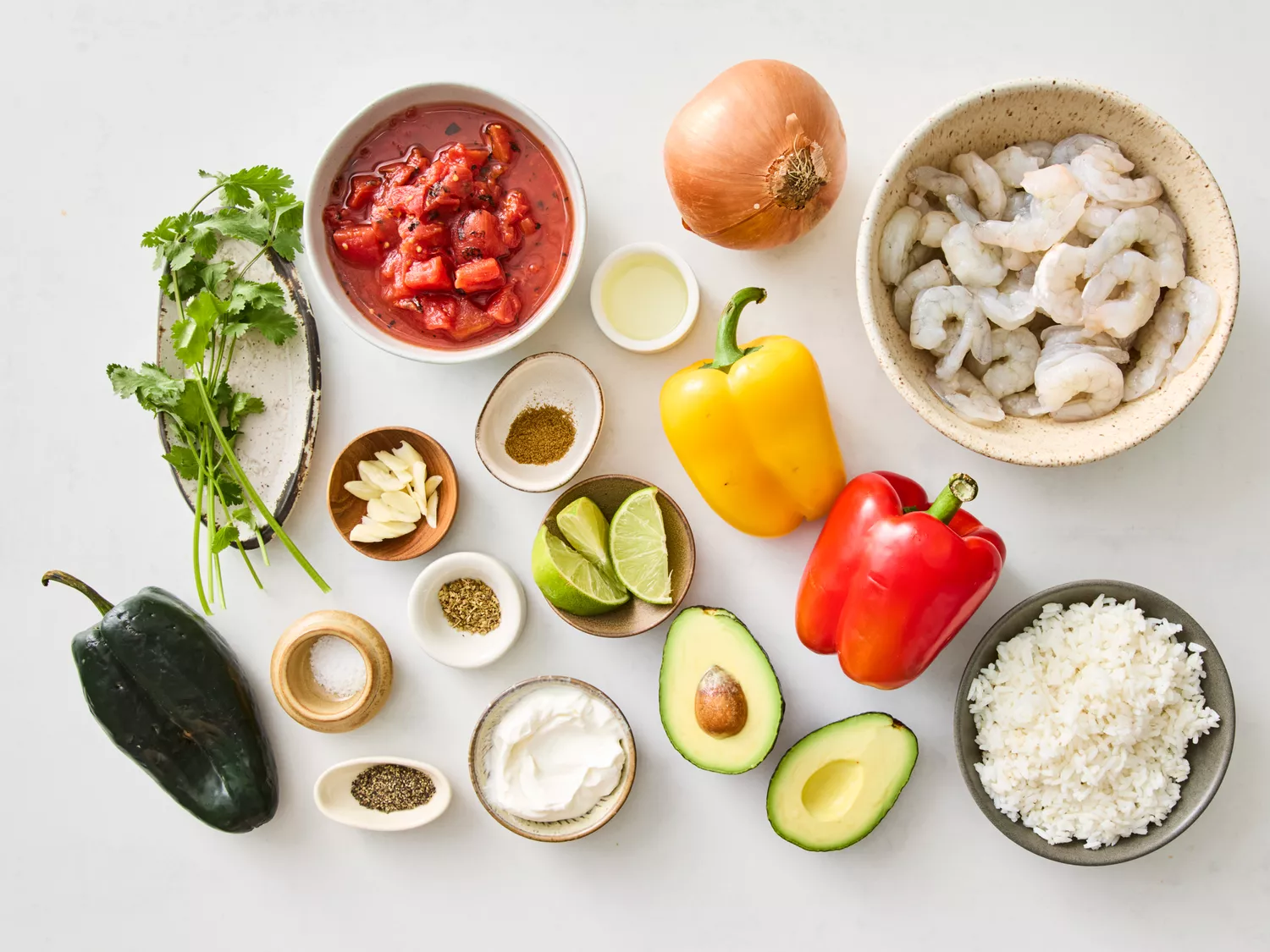Ingredients for shrimp fajita casserole, including shrimp, peppers, and rice